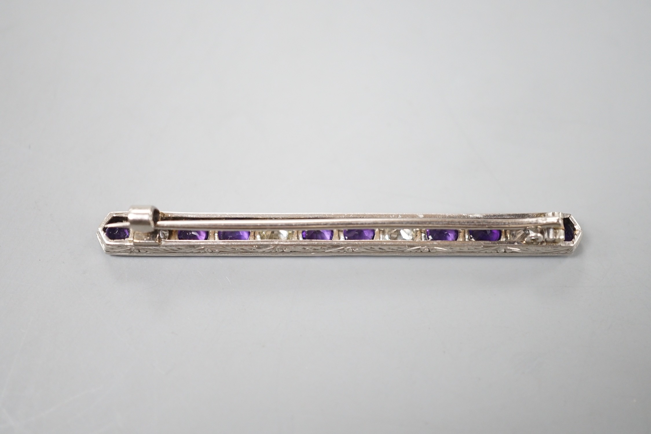 A mid 20th century white metal, amethyst and diamond set bar brooch, 57mm, gross weight 4.5 grams.
